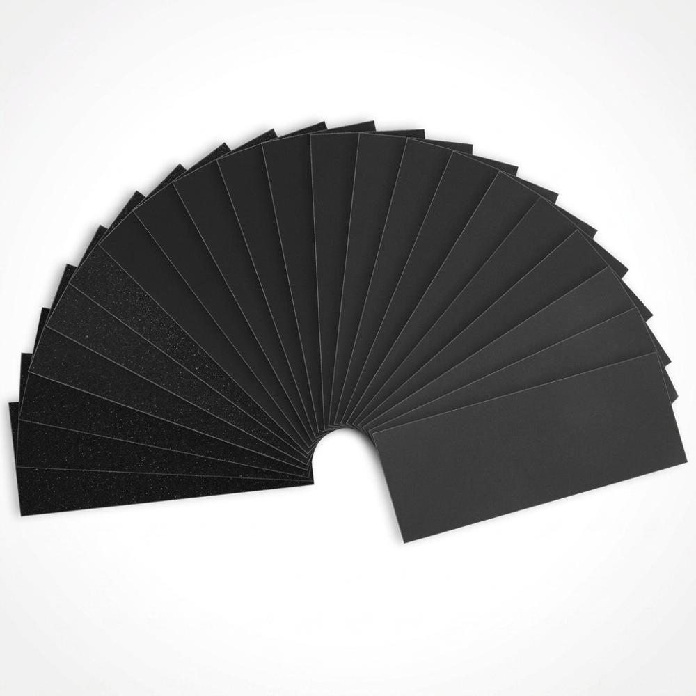 Wet/dry fine-grit sandpaper assortment for smoothing cured clay